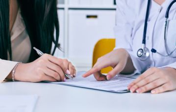 Physician signing a contract
