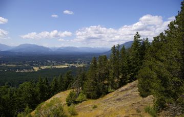 mountain side in front of green valley near Port Alberni Vancouver Island British Columbia Canada with blue sky backdrop