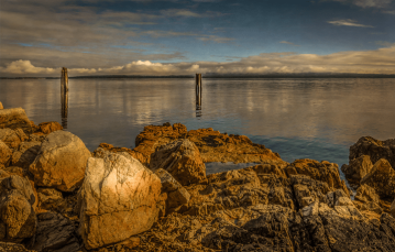 Rocky ocean shoreline and cloudy horizon near southern Vancouver Island.