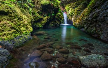 Waterfall into a clear pool